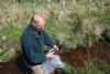 Mervyn Finlay checks for fly life in the stream