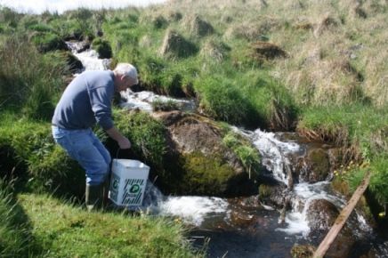 Eugene McCormick releases fry into mountain stream of Blackwater